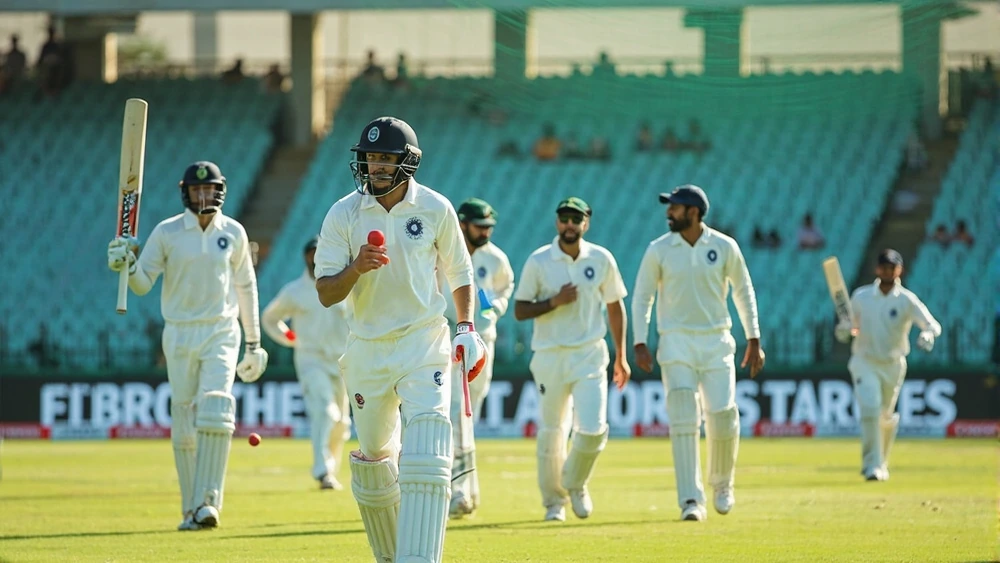 MI batting role continuity review Blue-clad cricket batting group rotating roles during bright daytime net practice